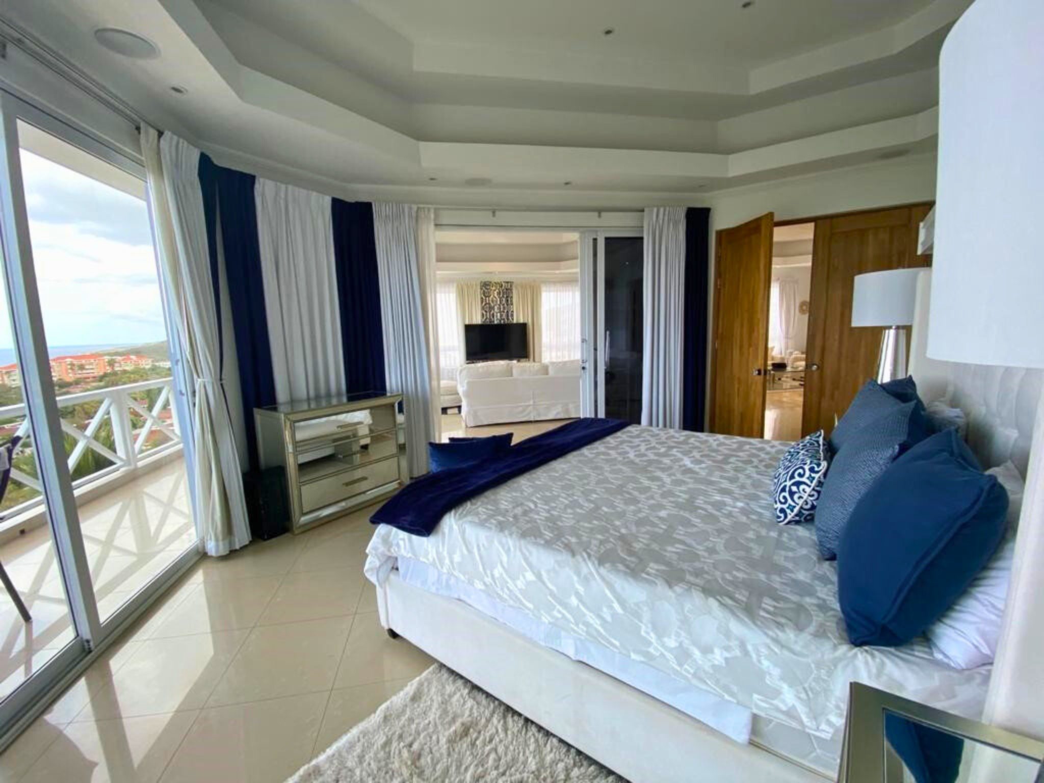 Luxurious bedroom in La Vista Resort Penthouse featuring elegant decor, large windows with scenic views, and stylish furnishings, ideal for high-end rental in Curaçao.