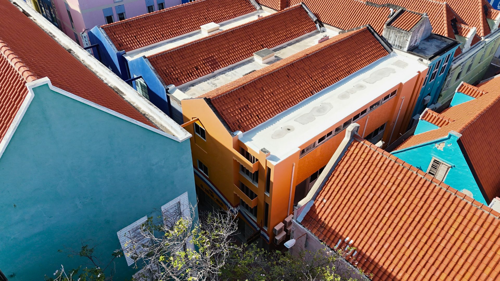 Overhead view of colorful rooftops in Punda, Curaçao, showcasing a mix of traditional and modern architecture, emphasizing the vibrant commercial property landscape.