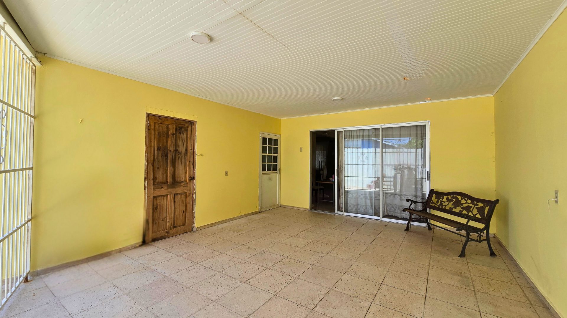 Large covered patio space with tiled flooring