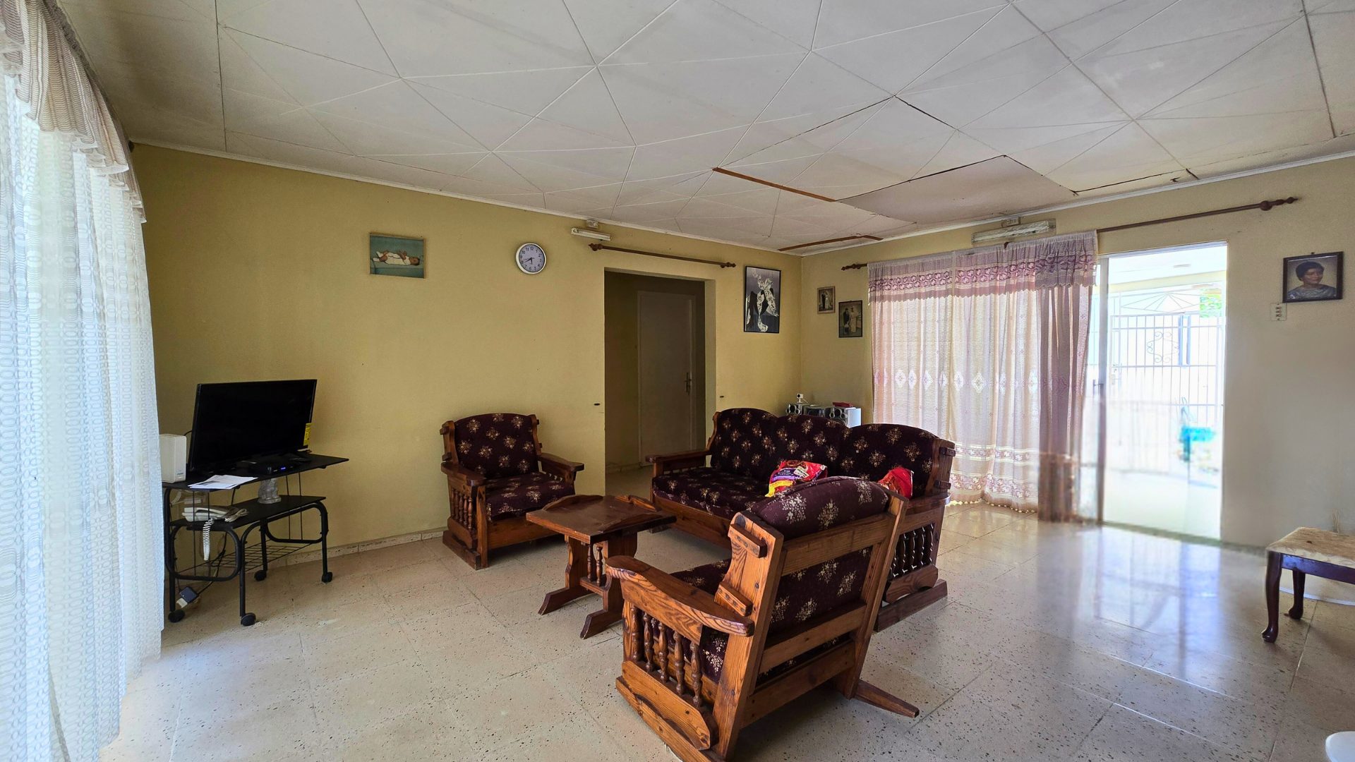 Bright living room with tiled floor and natural light