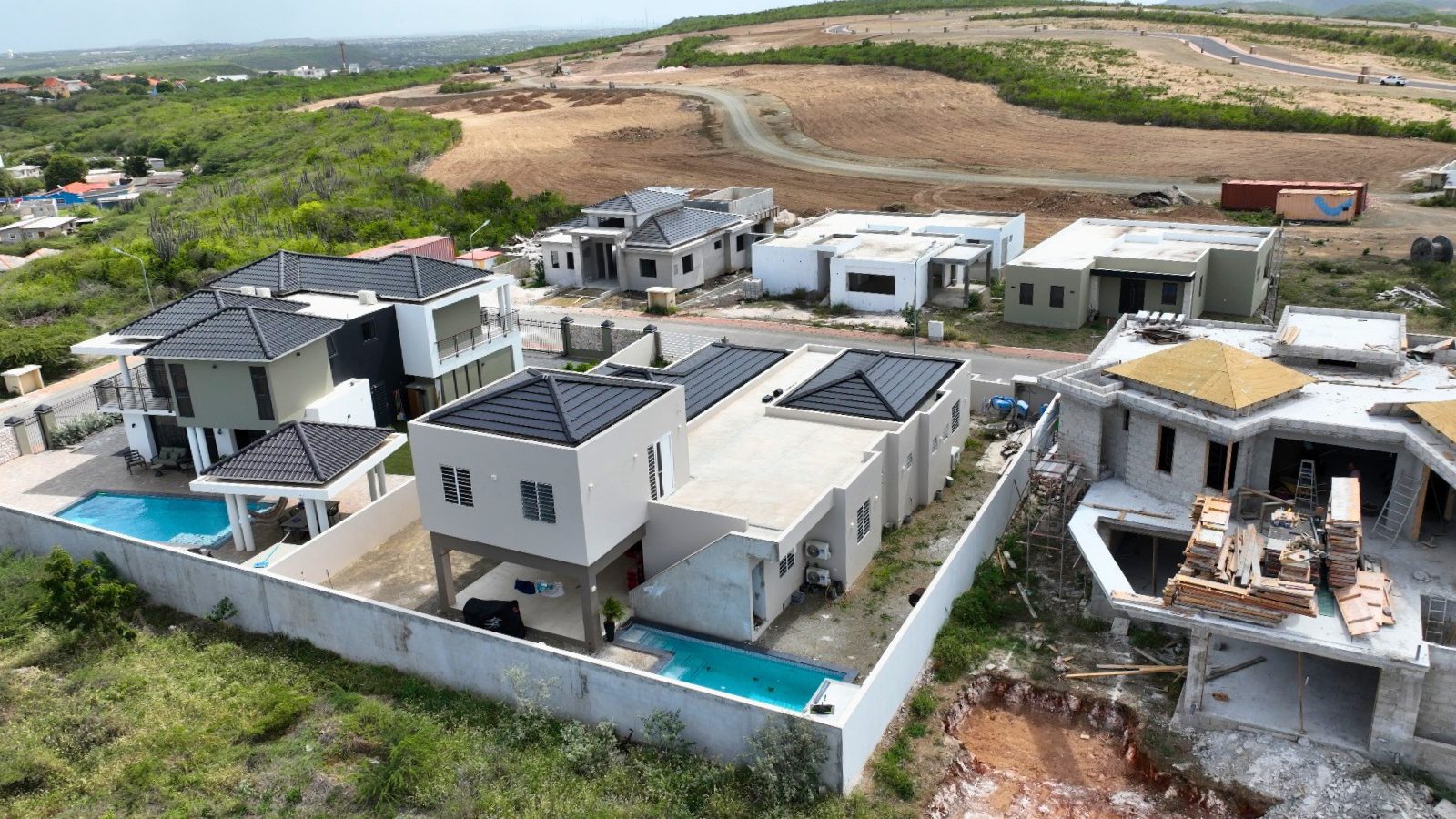 villa for sale in curaçao real estate at Harmonie aerial view of modern residential villas with clean architecture