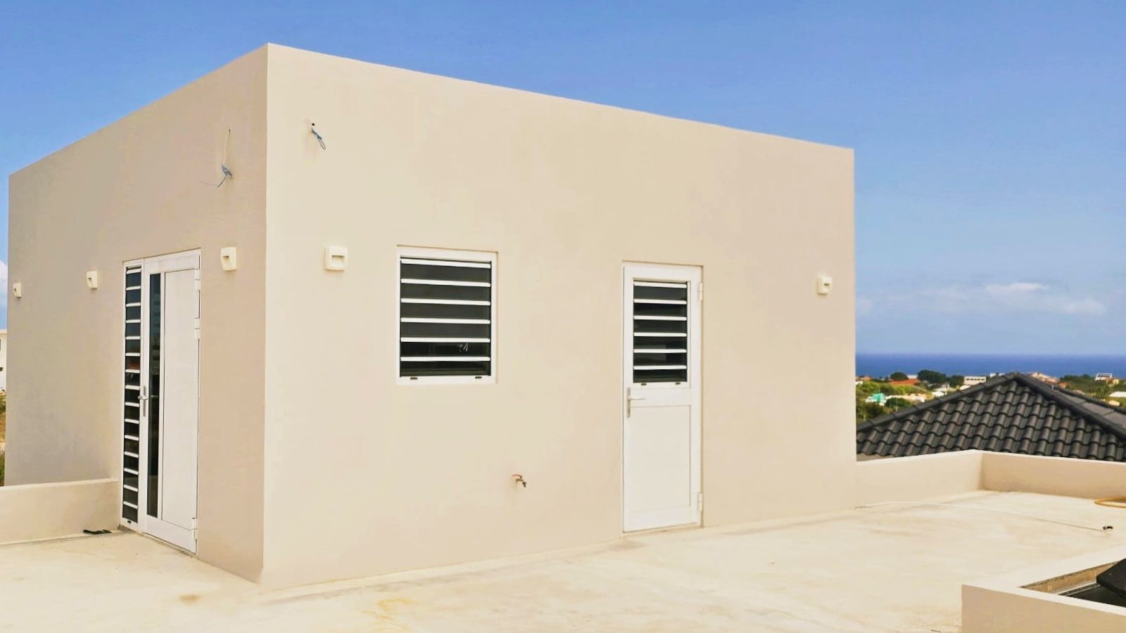 villa for sale in curaçao real estate at Harmonie side exterior with clean lines and functional layout