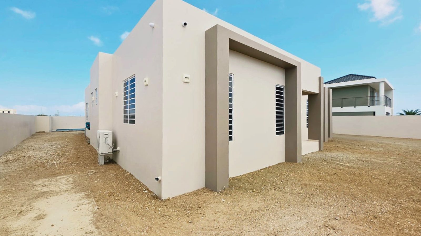 villa for sale in curaçao real estate at Harmonie side exterior with clean lines and functional layout