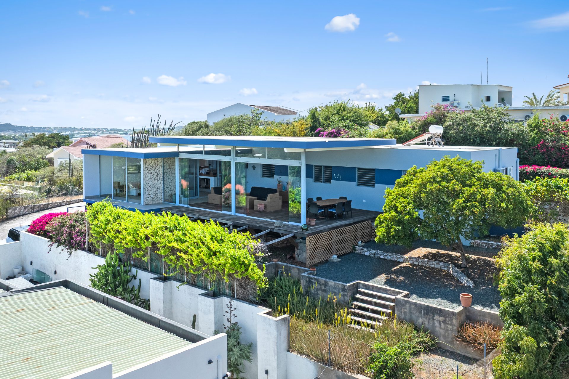 Curaçao real estate for sale angled exterior view showcasing contemporary architecture and lush greenery.
