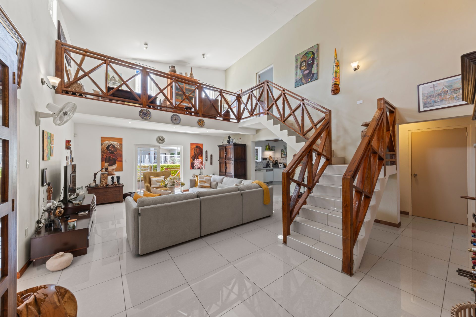 jan thiel villa for sale - open-plan interior with staircase, kitchen island, and spacious living area