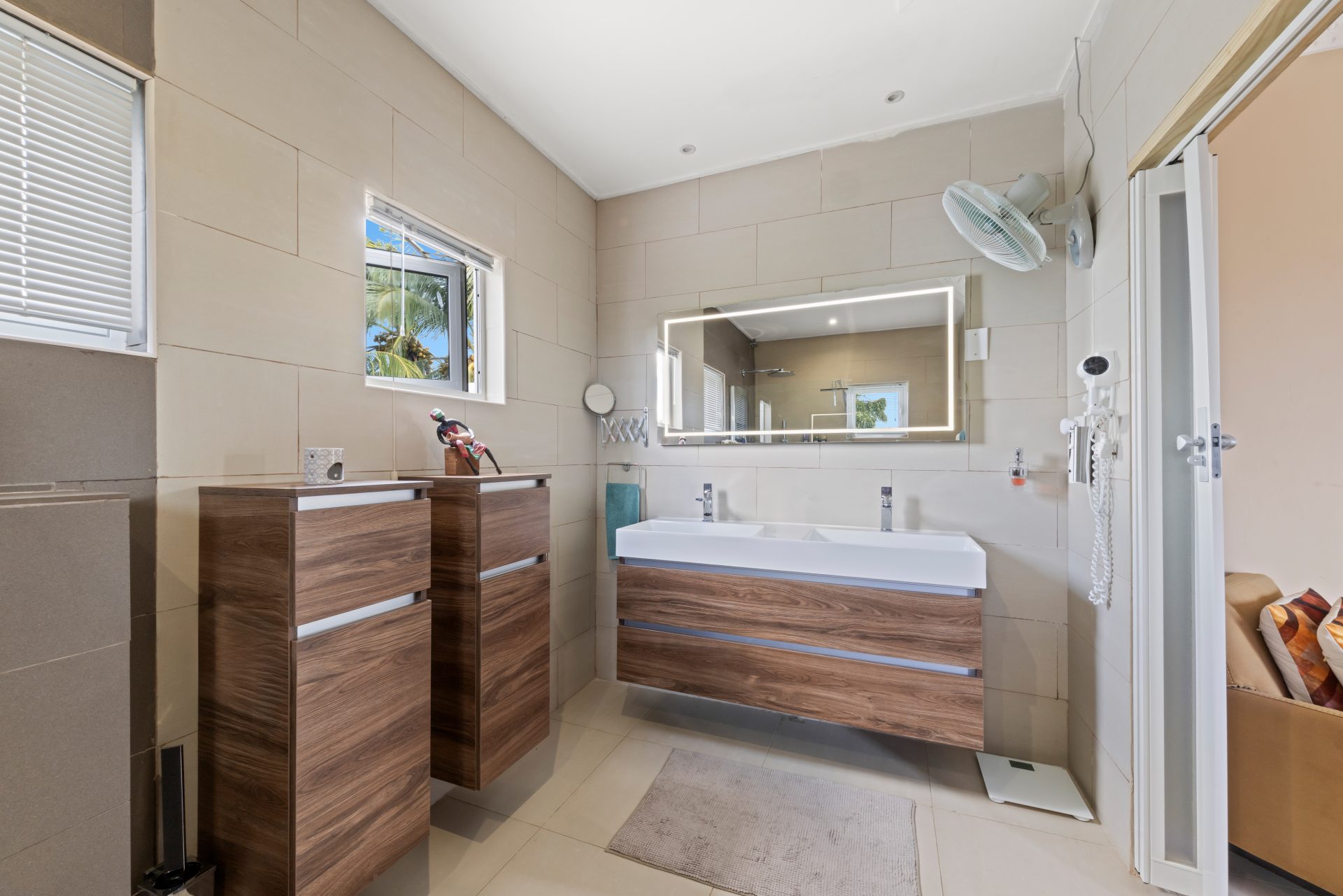 jan thiel villa for sale - bathroom with tiled shower, toilet, and natural light