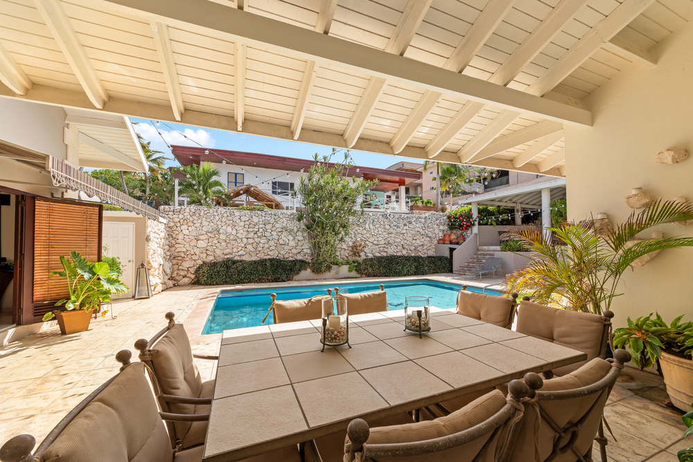 5-bedroom villa for sale in curaçao real estate at Jan Thiel shaded patio with seating and tropical ambiance