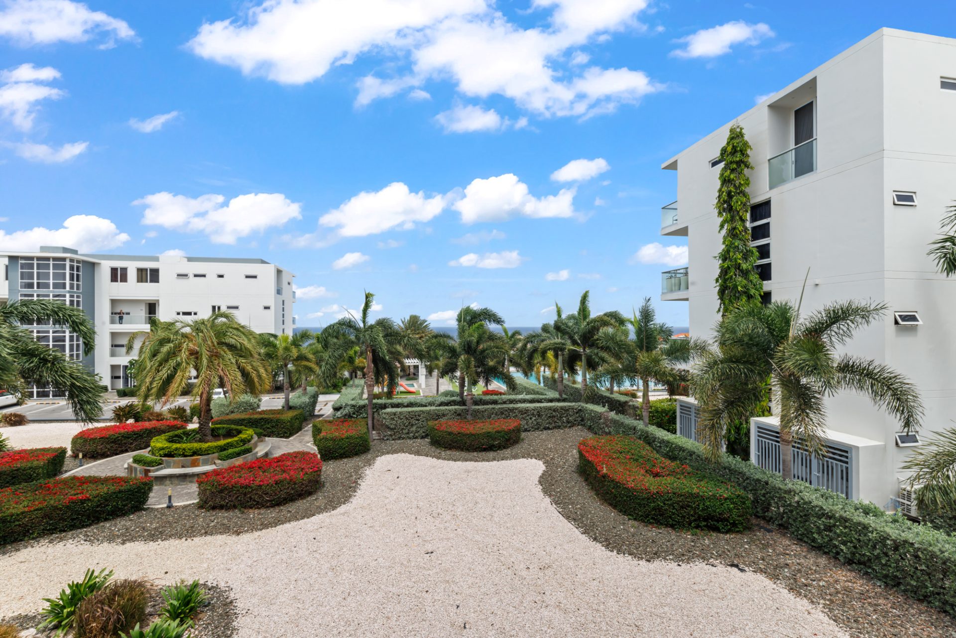 Private terrace of a fully furnished condo for sale in resort overlooking landscaped grounds.